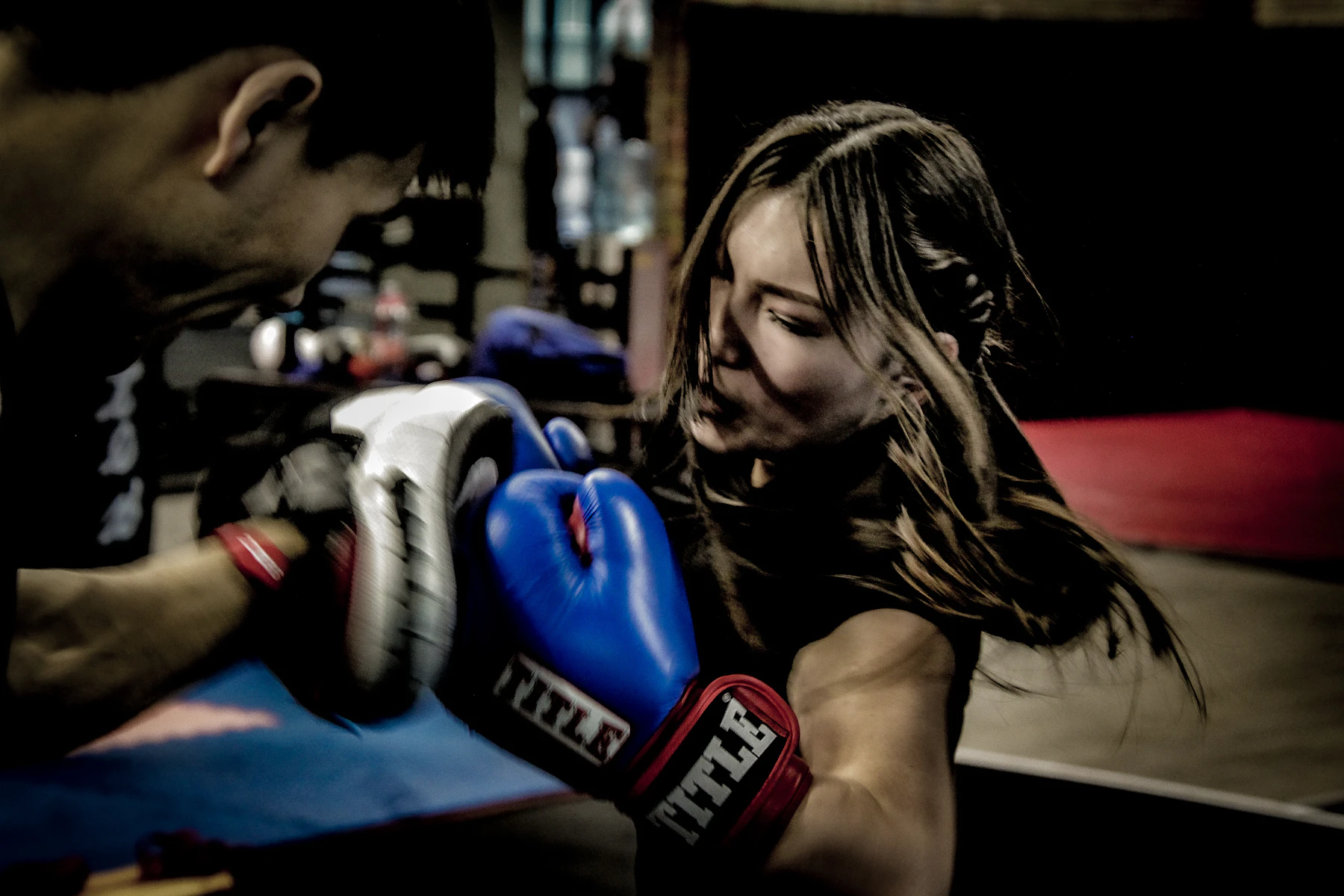 A real boxer training with focus mitts